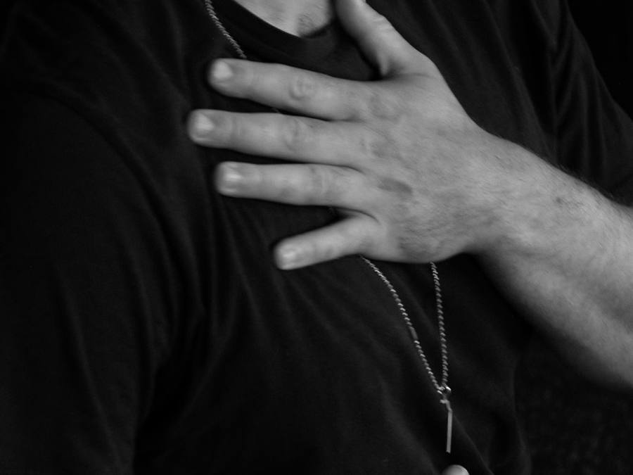 Close up of a hand resting on the chest