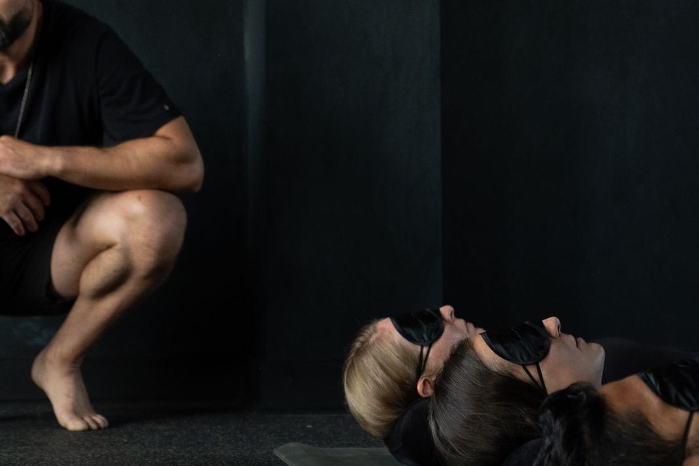 Tarik guiding a breathwork class under the studio arches