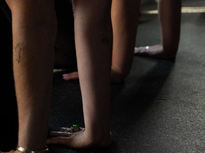 A group standing barefoot in the studio