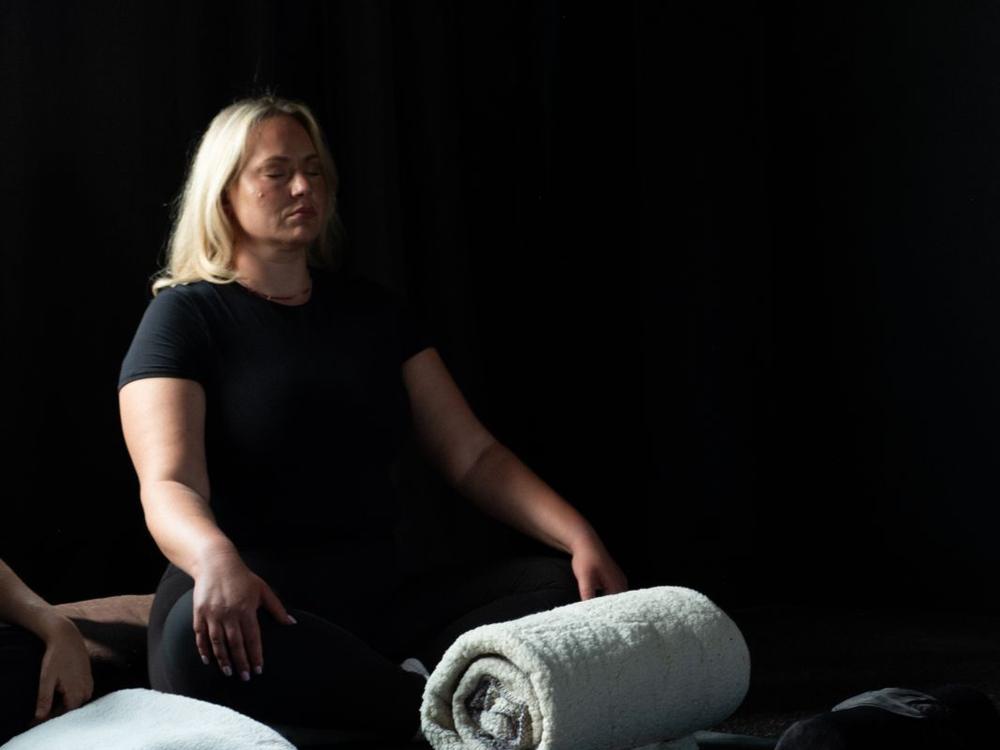 A bolster and blanket set out before a session